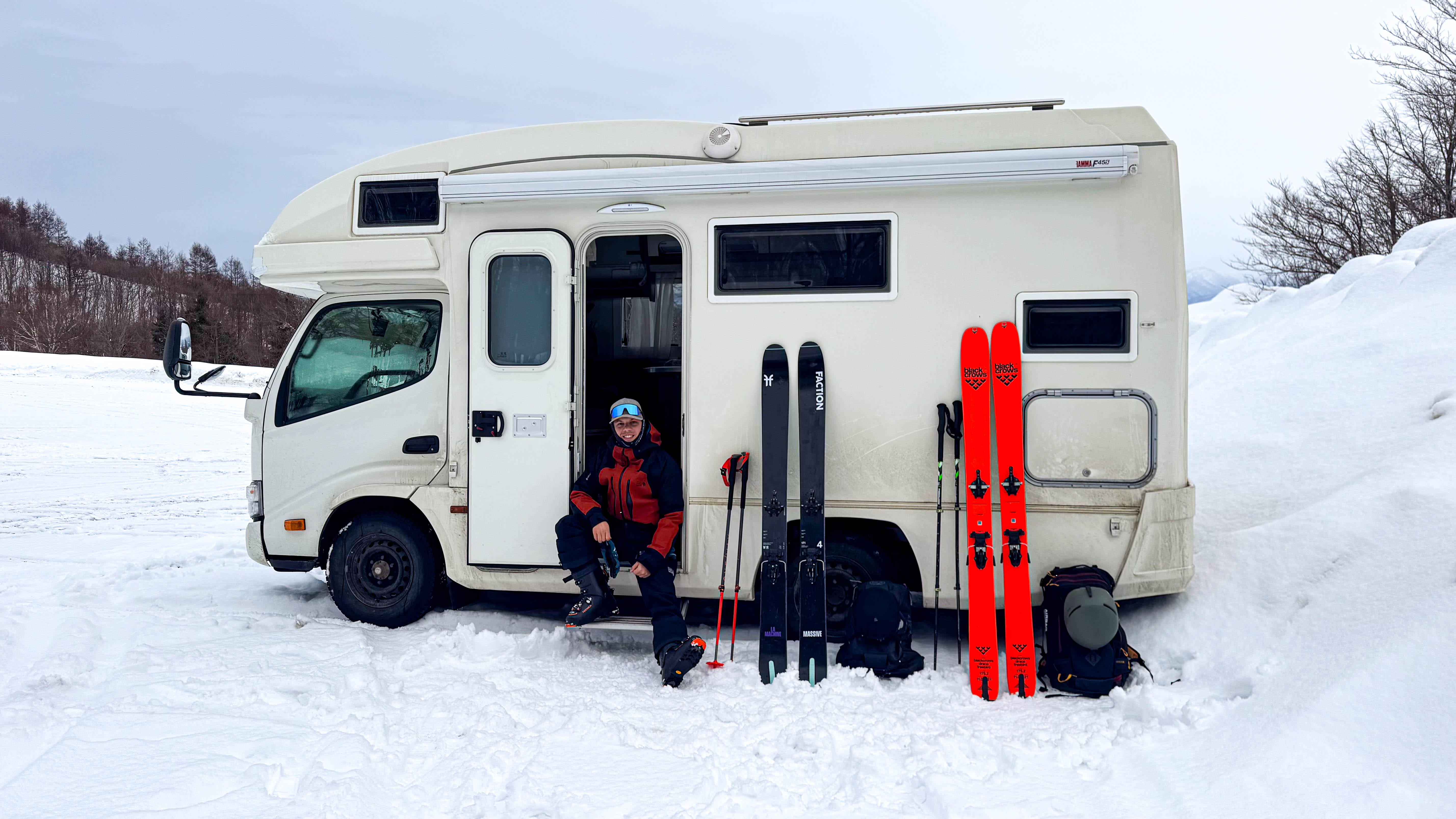 Camper van in snowy Japan near a road sign
